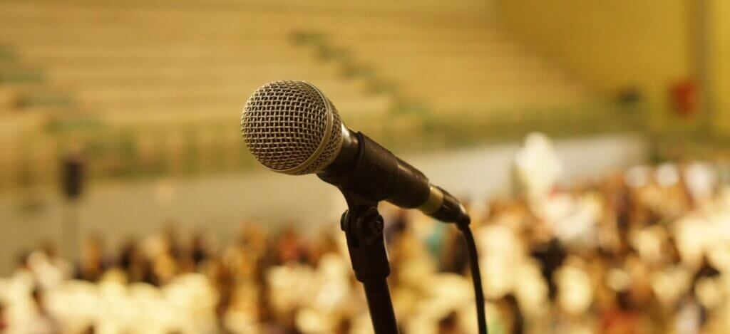 Karen Eber - Banner - Microphone in front of Auditorium